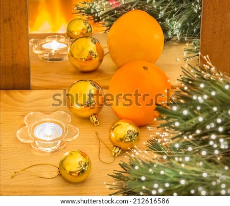 Christmas composition with orange and gold Christmas balls and their reflection in the mirror.