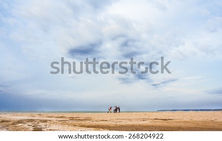 The game in the mafia on a deserted beach on the background of storm clouds