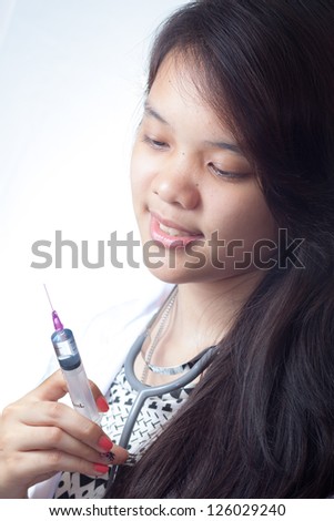 Portrait of young doctor against white background