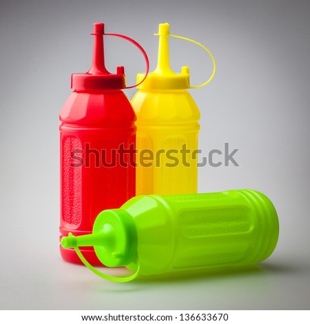 Colorful plastic bottle for sauce containing