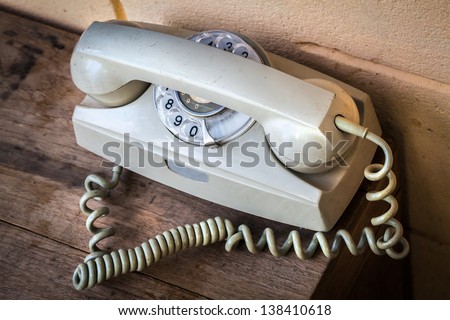 Old telephone placed on wooden table