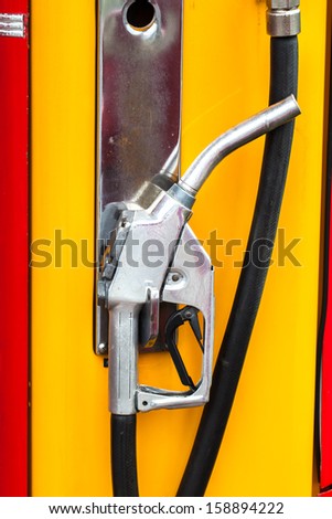 Retro petrol pump hose at a gas station