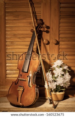 Broken violin on wooden floor