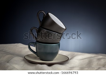 Three stacked cups on white cloth