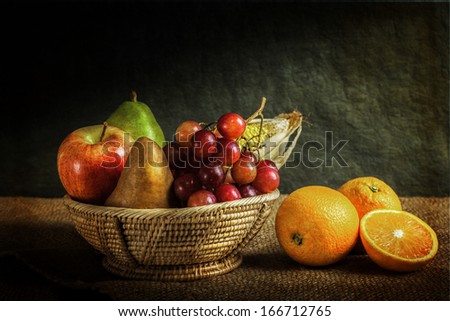 Still life fruits, fresh fruit display in wooden basket and some place on sack cloth