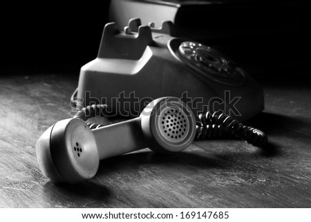 vintage old telephone, black retro phone is on the wooden table, still life