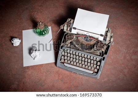 Old English type writer with paper sheet and aged lantern, still life