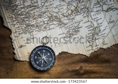 Old compass and ancient map