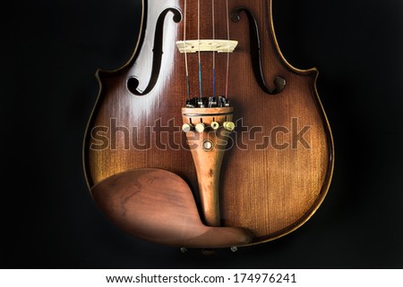 Violin orchestra musical instruments isolated on black. Classical music instrument