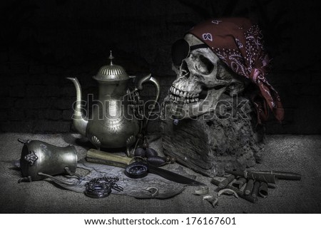 Still life, pirate skull with cigar in the mouth, compass on ancient map, knife and pocket watch hang on the log