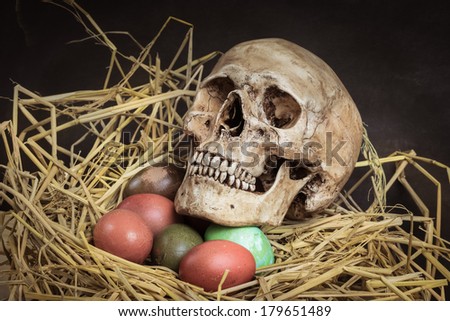 Still life with human head, colorful Easter eggs in nest from top side view