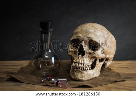 Still life with human skull and sciences test tube