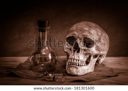 Still life with human skull and sciences test tube