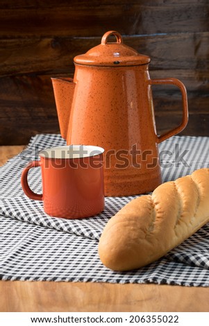 French bread with tea pot and cup on table cloths