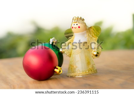 Christmas ornament green and red balls with fairy in golden dress on soft background