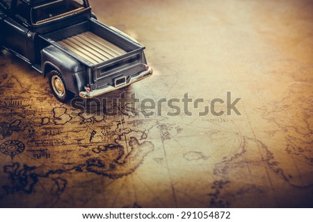 An old truck toy on a Treasure map background