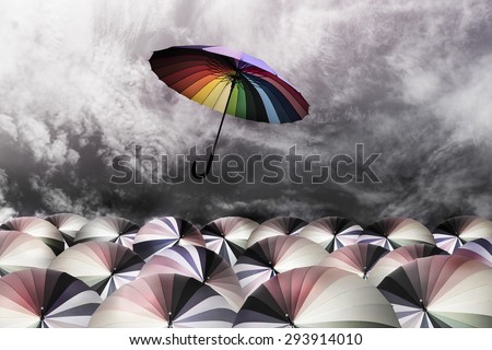rainbow umbrella fly out the mass of umbrellas