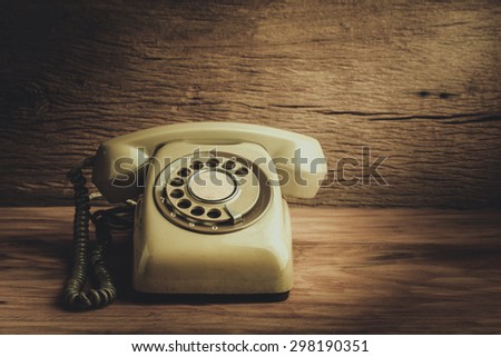 Still life with old green telephone on wooden table