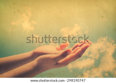 Human open empty hands with palms up, over blurred nature background.
