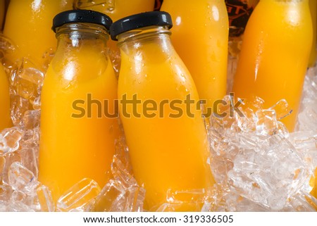 Orange juice bottles on the ice box