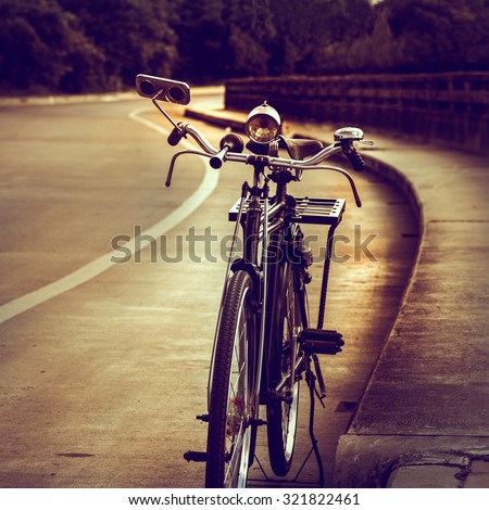 Old bicycle on the bridge, vintage effect style.