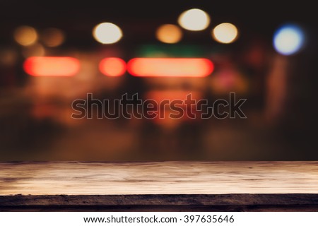 Empty top of wooden table or counter on cafeteria, bar, coffeeshop background. For product display