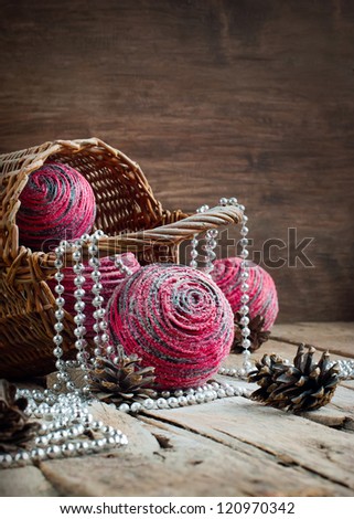 Christmas Card with Pink Natural Balls, Pine Cones, Beads on Wooden Background
