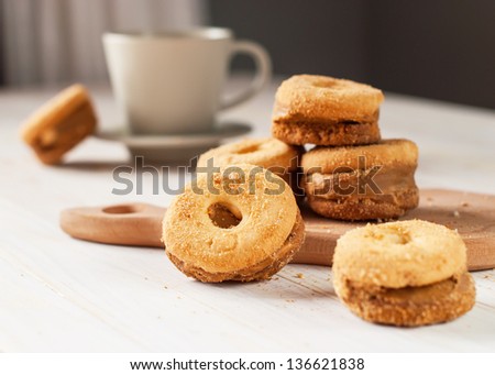 Shortcake in the circle form on the wooden table with cup of tea