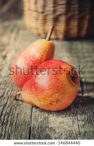 Simple Composition with Two Red Pears on wooden table, toned warm