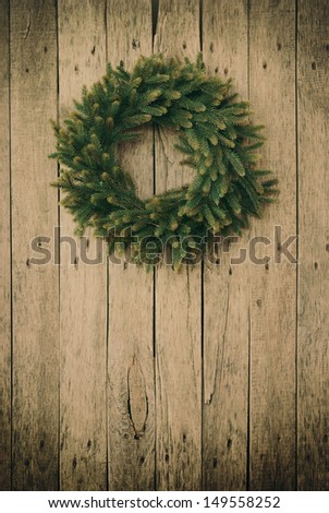 Green Christmas Wreath on a wooden planks,toned