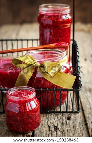 Fresh Raspberry Jam in a jars on the wooden table, close up