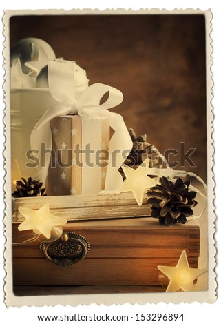Vintage Christmas Card with Gifts, box, white ribbon and pine cones, retro photo frame