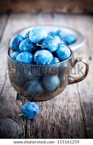 Summer Blue Plums Berries on the wooden background