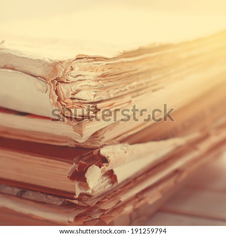 Stack of Old Books with Tattered Pages, close up, toned image, square