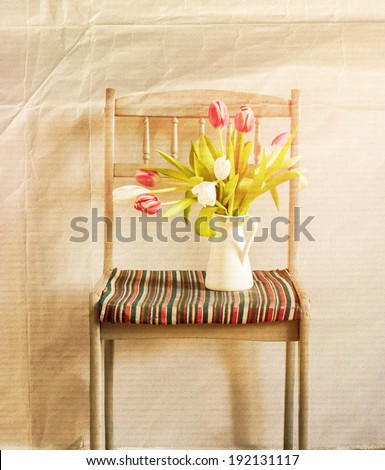 Tulips in Composition on the Chair, Spring Flowers in a Home Decoration on grey background, seasonal home interior