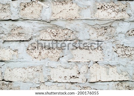 White Cinder Block Wall Laid in Construction Laying with a Rough Cement Insertion