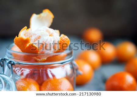 Composition with Open Tangerines in a Jar. Rural style. Russian tradition to eat this fruits on Christmas