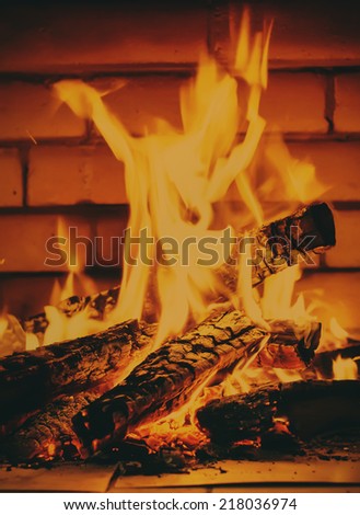 Firewood in Bright Fire, Fireplace from Brick, toned image