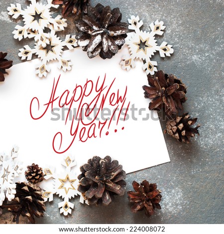 Christmas Card with Decoration Snowflakes  and Pine cones,  Message Happy New Year on the letter, isolated on white