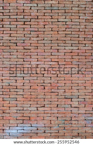 Porous red bricklaying without filling with cement, background. Vertical image