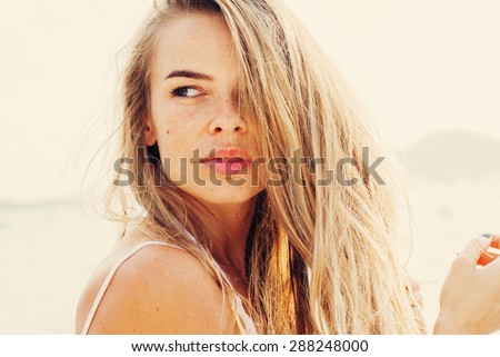 Beautiful Young Woman with Long Fair Hair, Looking to the Right. Toned Effect