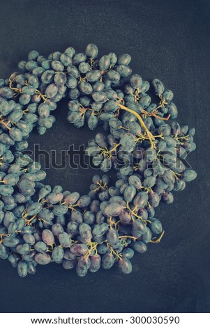 Blue Grapes on Old Wooden Background. Country style. Toned Image
