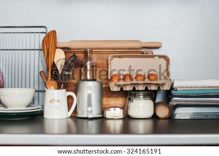 Dishes, Tableware and Fresh Grocery Products stand on a Kitchen Table