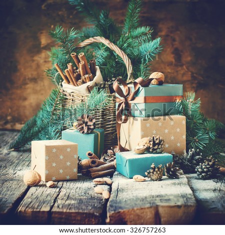 Christmas Card. Gifts with Boxes, Basket, Pine Cones, Walnuts on Wooden Background. Toned