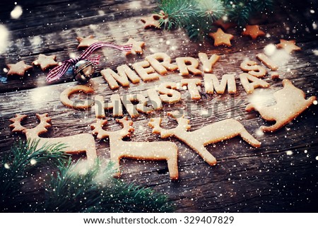 Card with Gingerbread Cookies. Baked Letters Merry Christmas, Bell, Fir Tree, Figures of Deers, Sledge, Stars. Toned