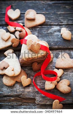 Cookies Valentine\'s Day cards with Red Row on Wooden Table. Shape of Hearts. Valentines theme