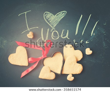 Cards with Cookies in Shape of Hearts for Valentine\'s Day, Message I Love You by Chalk on Dark Wooden Background. Valentines theme. Toned. Vintage Effect