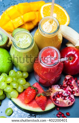 Color Fresh Juices Smoothie Bottles Red Green Orange Tropical Fruits Selective Focus Black Background Healthy Beverage Top View