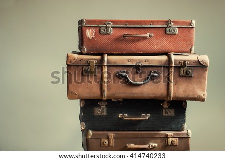 Vintage Pile Ancient Suitcases Form of Tower Design Concept Travel Luggage Traveler on Shabby Beige Background