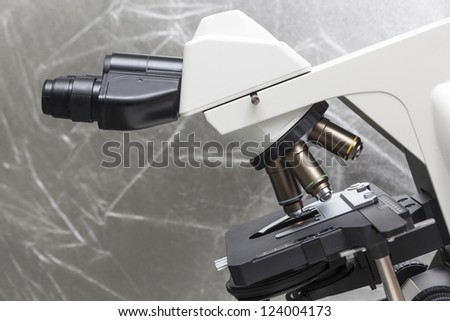 Microscope in bio lab closeup under studio lights